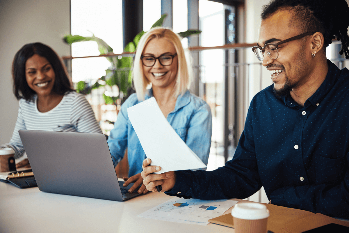 Colleague looking happy reading paperwork on meeting room